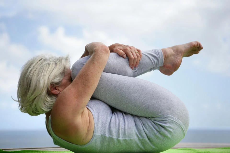 Woman doing a yoga stretch outdoors