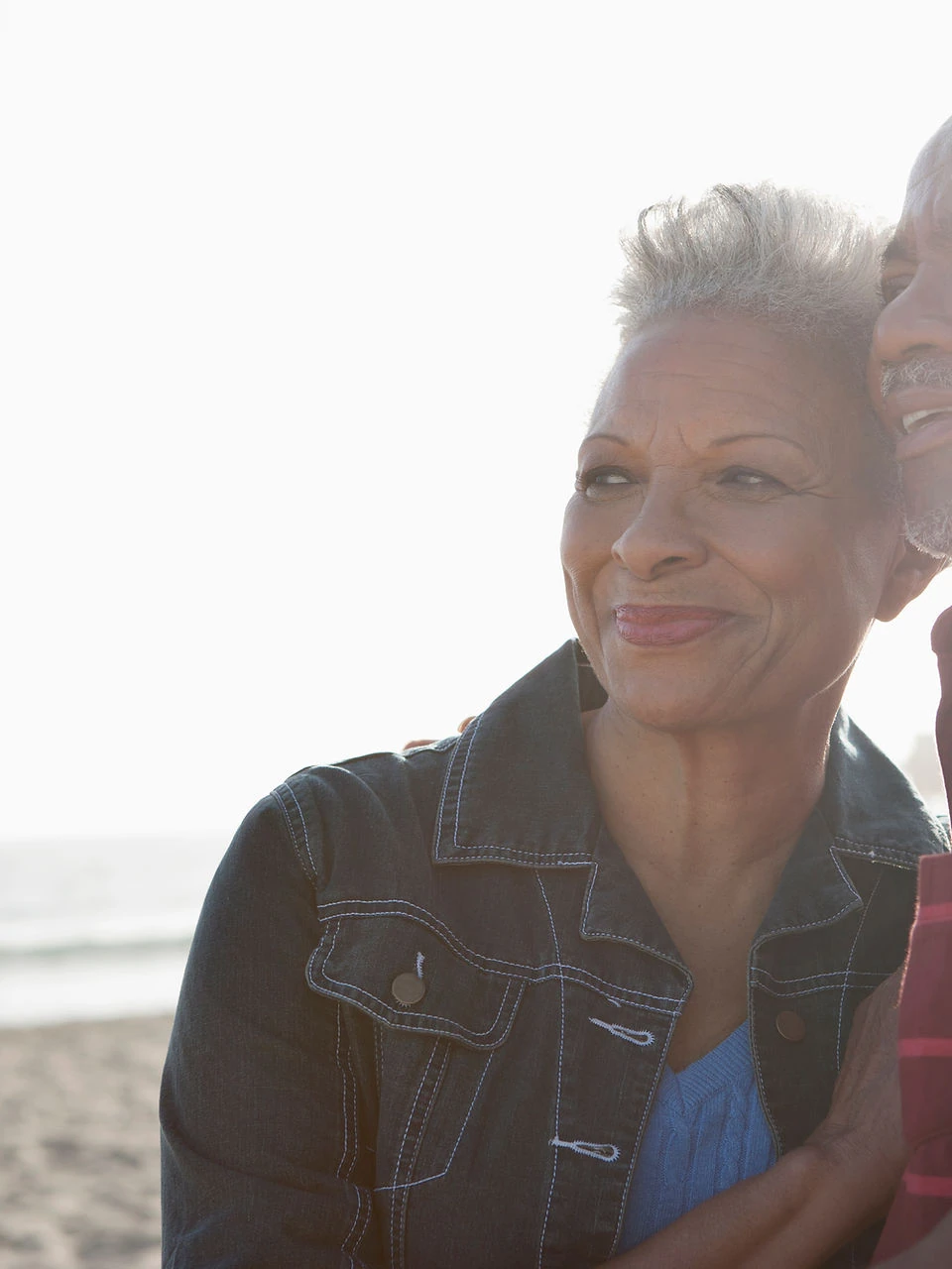 Smiling woman with short gray hair at the beach